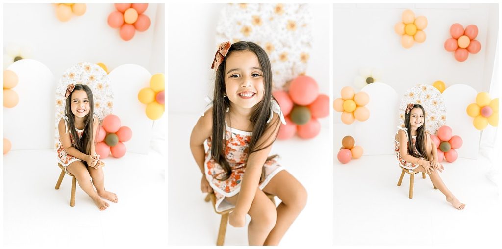 girl smiling with colorful balloons for birthday photoshoot