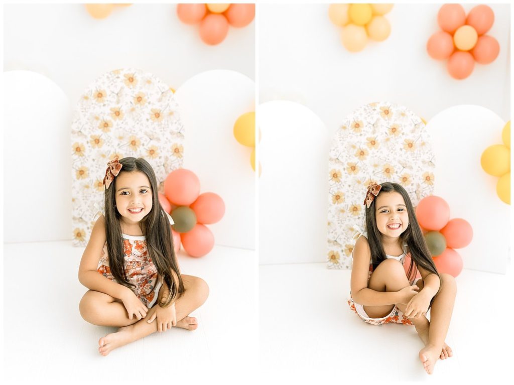 girl in floral romper with flower balloons