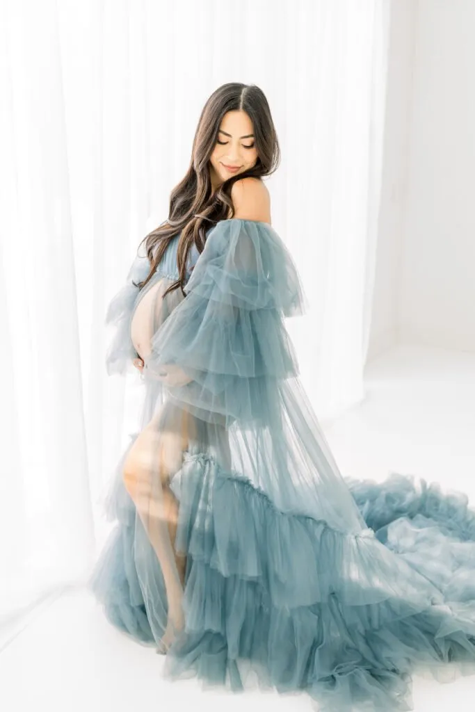 woman in dramatic blue maternity dress