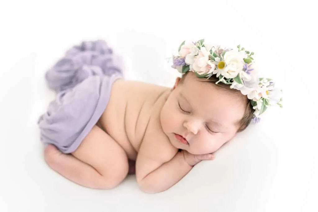 newborn photography baby girl posed in purple