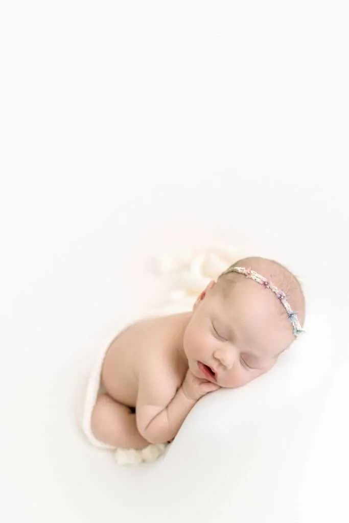 newborn girl in a rainbow crown