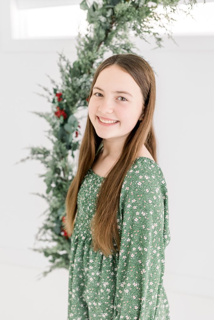 girl in green dress for christmas mini session