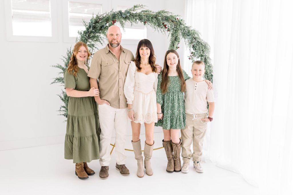 family with wreath for holiday photos