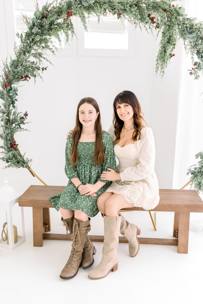 family sitting on a bench for holiday session near me