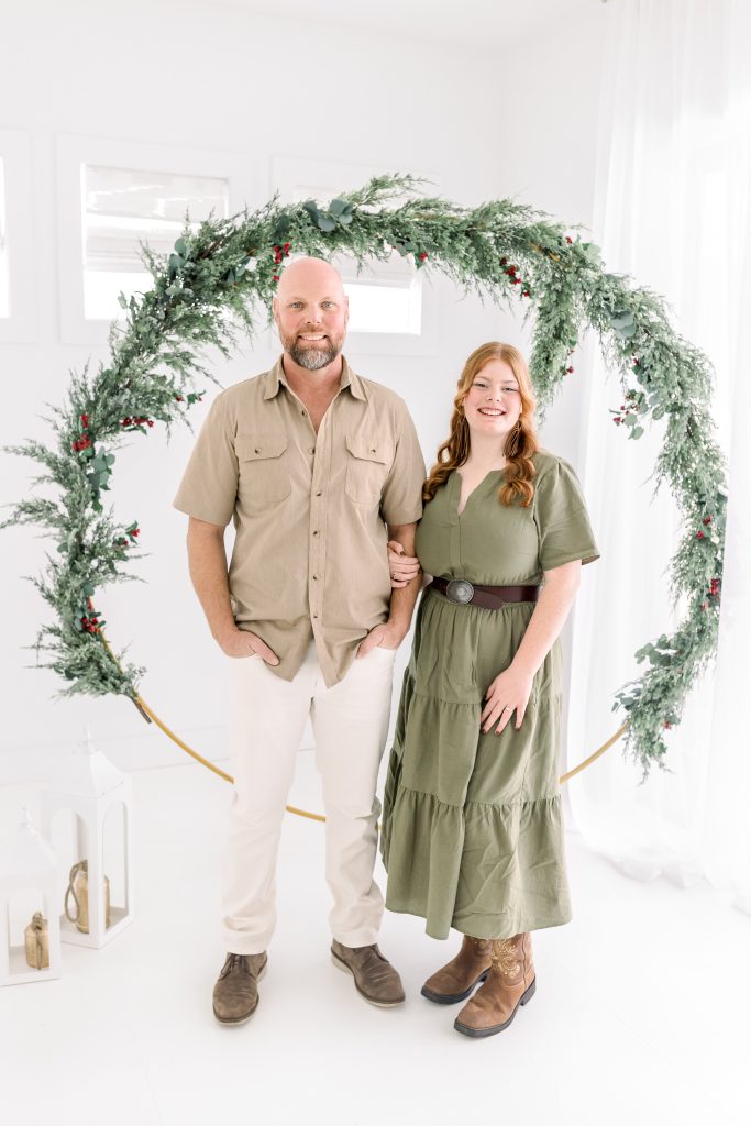 father and daughter pose for holiday card photo session