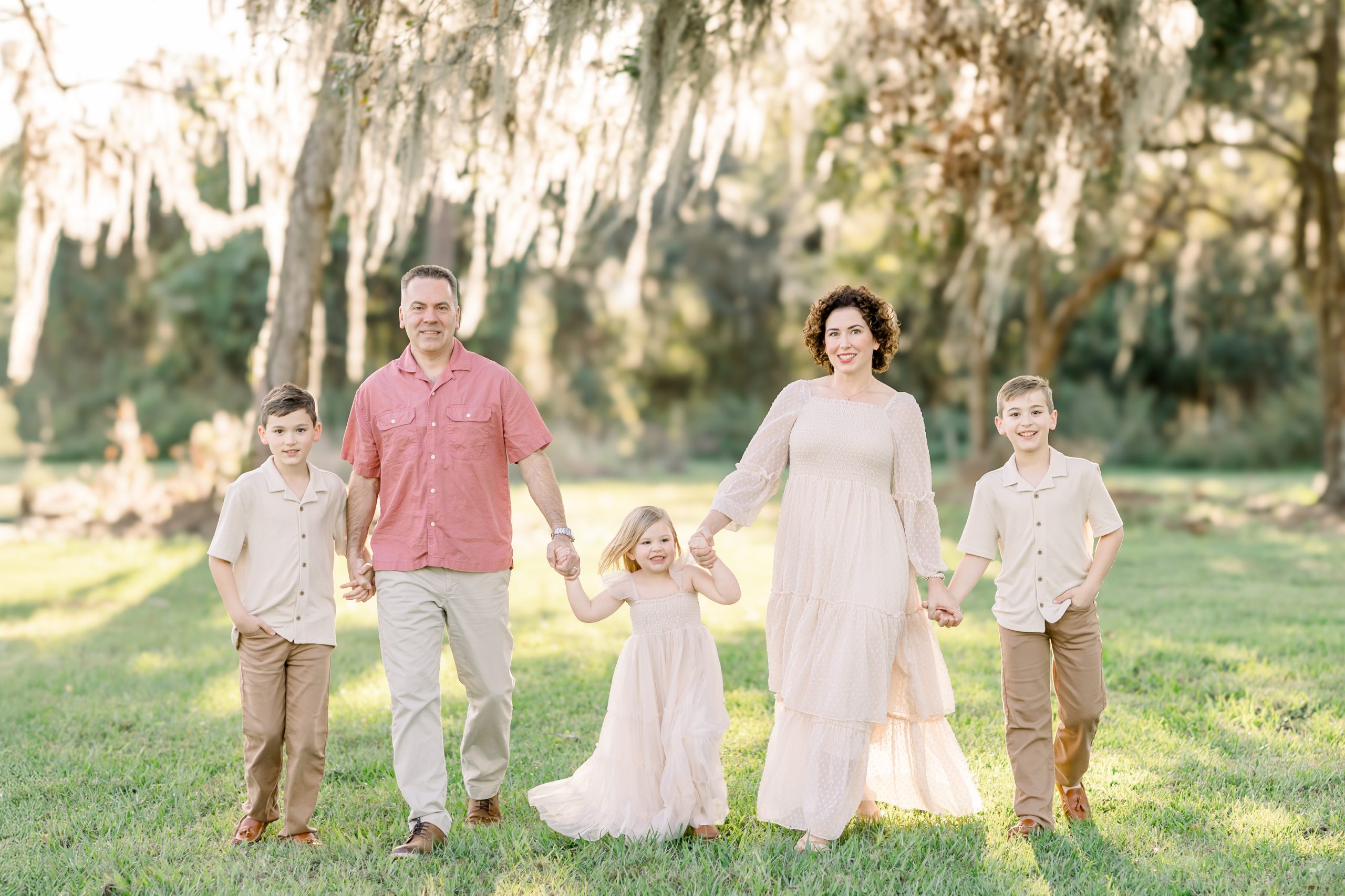 family smiling and walking for family photo
