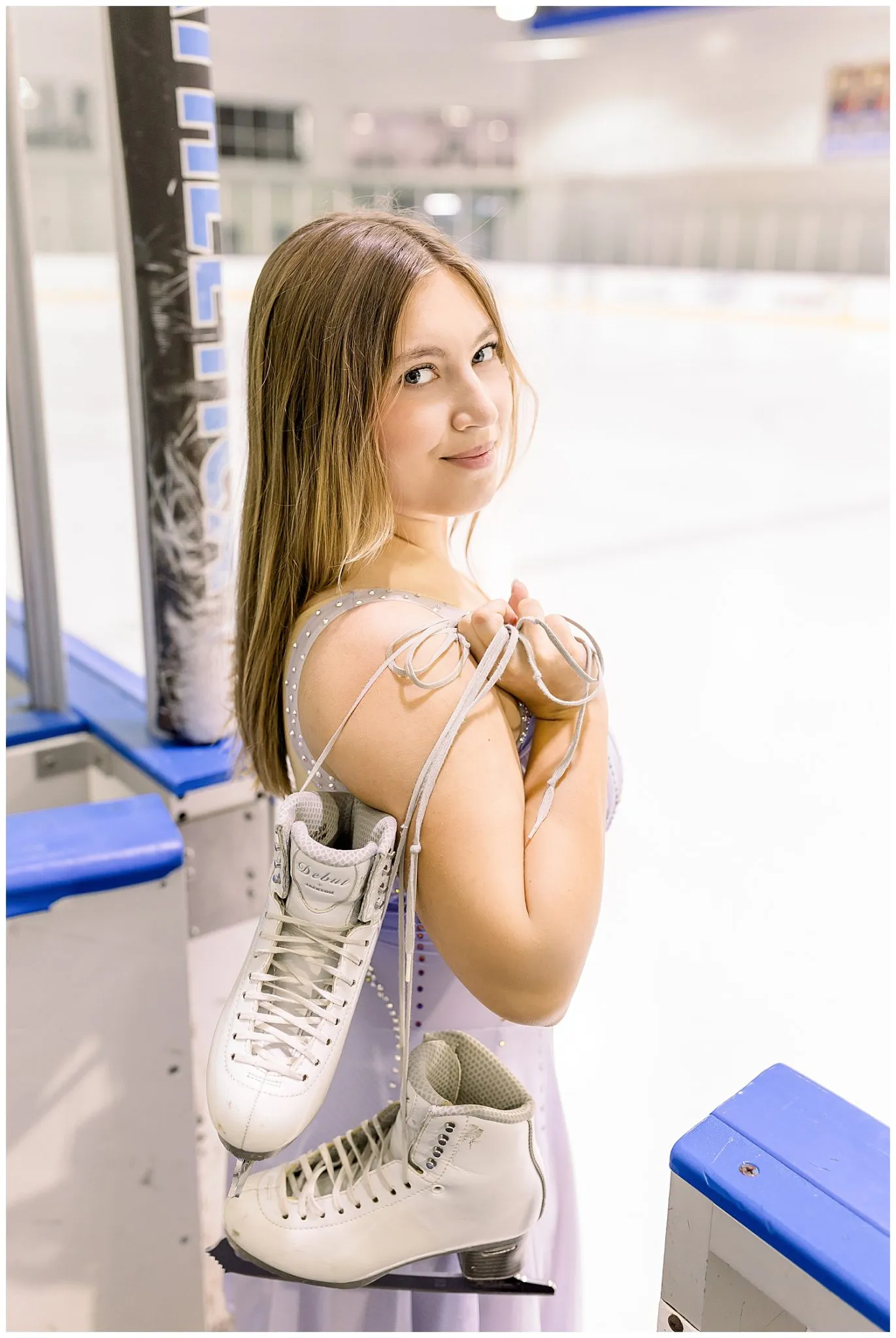 senior photos of figure skater holding ice skates