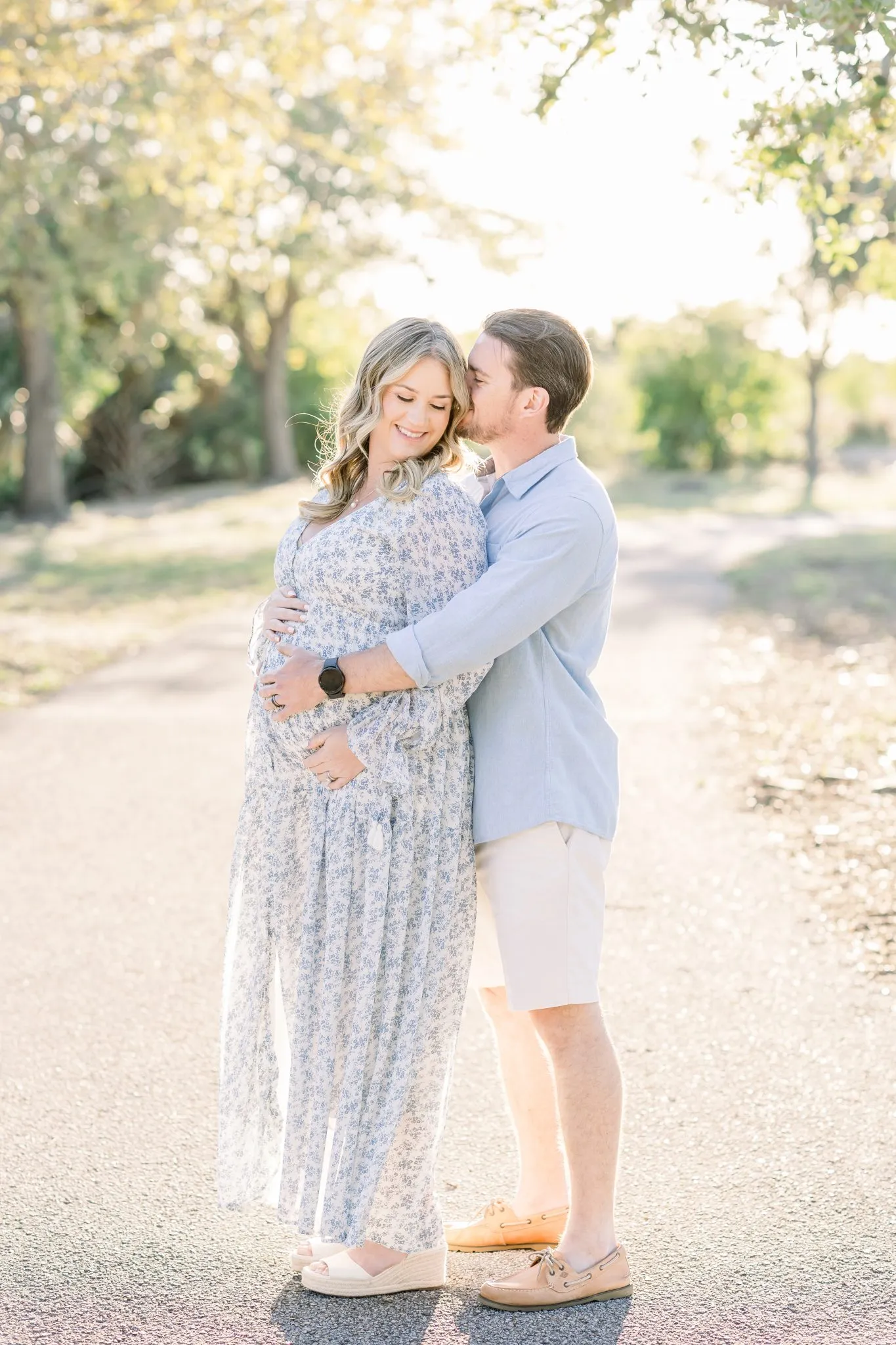 Sunset maternity photos on a pink-tinged Tampa beach featuring expecting parents Amy and Sean.