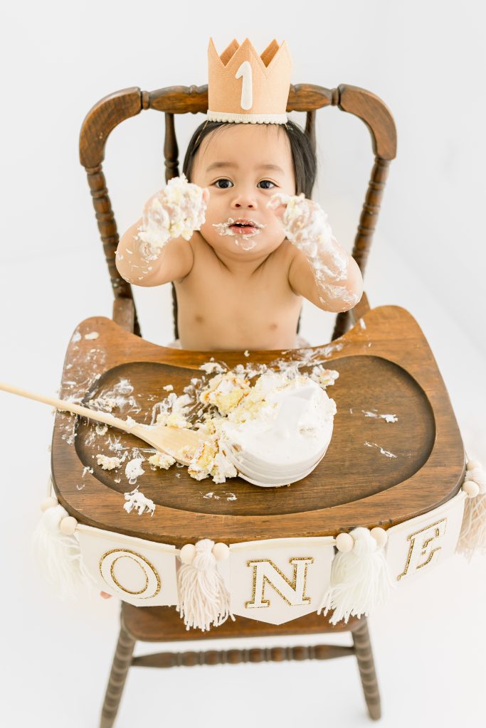 baby smashing cake at wild one portraits