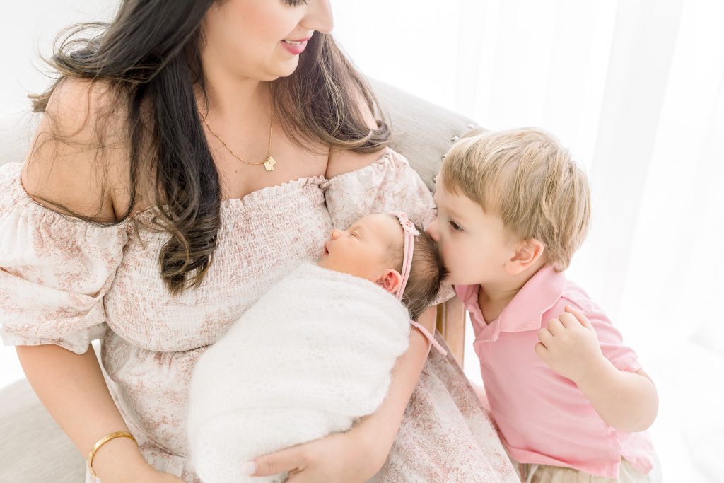 Bright and airy newborn photography studio in Wesley Chapel featuring white curtains and natural light for family portraits.